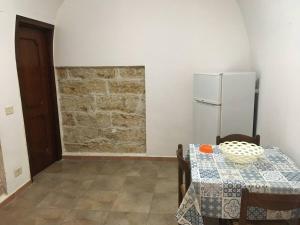 a dining room with a table and a refrigerator at Terrasini 2000 Casa Vacanze in Terrasini