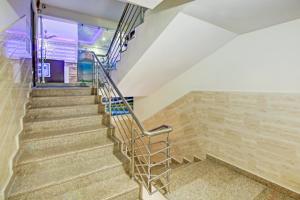 a staircase in a building with wooden walls at Hotel O Island in Meerut