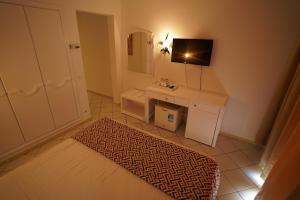 a small bathroom with a sink and a mirror at Hotel Nesrine Hammamet in Hammamet