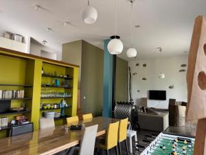 a dining room with a table and a couch at A la folie des vosges in Fraize