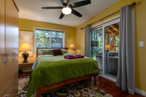 a bedroom with a green bed and a window at Moose Manor in Packwood