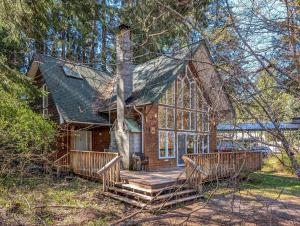 a log home with a porch and a large window at Moose Manor in Packwood