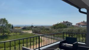 a view from the balcony of a house at Apartman mirna lokacija s pogledom i parkingom in Vodnjan