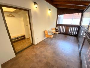 a hallway with a table and chairs in a building at Chopok Juh apartmán Yeti in Horná Lehota