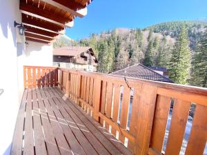 a wooden balcony with a view of a mountain at Chopok Juh apartmán Yeti in Horná Lehota