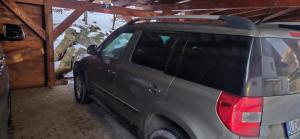 a car parked in a garage next to a building at Chopok Juh apartmán Yeti in Horná Lehota