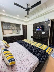 a bedroom with a large bed with a ceiling fan at Namah 1 BHK Resort Homestay with KITCHEN -4 min from Prem Mandir in Vrindāvan