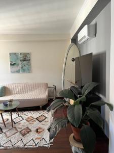 a living room with a couch and a mirror at Surf Nest in Machico
