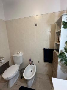 a bathroom with a white toilet and a sink at Surf Nest in Machico +22 photos