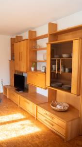 Apartment Rietheim في Rietheim-Weilheim: مطبخ بدولاب خشبي وطاولة