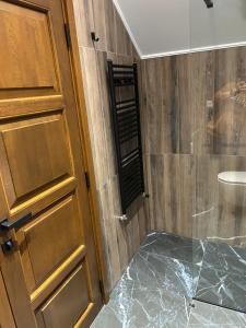 a bathroom with a shower with a glass door at Cabana Panoramic in Jieţ +20 photos