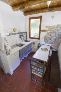 a kitchen with a table and a sink in a room at Agriturismo La Ca'Solare in Palaia
