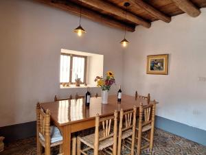 a dining room with a table with two bottles of wine at ANCASH Caraz Miski Wasi in Caraz