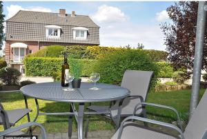 a table with a bottle of wine and two glasses at Ostseemuschel Laboe in Laboe