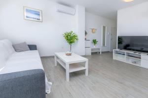 a living room with a couch and a table at Apartments Tonka in Primošten