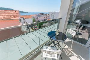 a balcony with a small table and two chairs at Apartments Tonka in Primošten