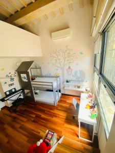 a childs bedroom with a tree mural on the wall at La Limonaia della Torretta Luxury Private Pool in Florence +33 photos
