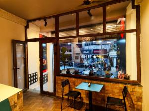 a window of a restaurant with a table and chairs at C2 Pods in Varanasi