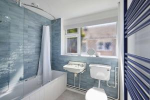 a bathroom with a sink and a toilet and a shower at Host & Stay - Park View in Thetford +6 photos