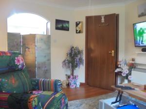 a living room with a couch and a door at 3 Station Court, Munlochy in Munlochy