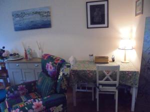a living room with a table and a chair at 3 Station Court, Munlochy in Munlochy +29 photos