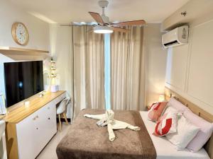 a room with a bed with a stuffed animal on it at AR's Staycation in Lapu Lapu City