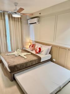 a bedroom with two beds with towels on them at AR's Staycation in Lapu Lapu City +1 photo