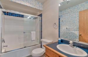 a bathroom with a sink and a toilet and a shower at Red Cedar - Unit 30 in Sunriver +36 photos