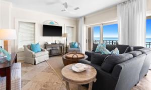 a living room with a couch and a table at Five Star in Inlet Beach