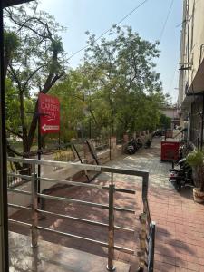 a sign on a fence next to a street at Hotel Garden View - Mansarovar in Jaipur