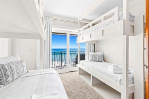 a bedroom with a bunk bed and a balcony with the ocean at Five Star in Inlet Beach +48 photos