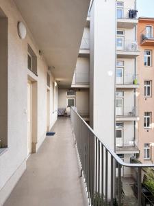 an empty corridor of an apartment building with balconies at Nook & Nite Apartments in Brno