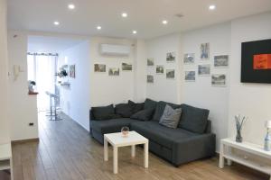 a living room with a couch and a table at al larghetto n5 in Salerno +20 photos