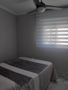 a bedroom with a bed and a ceiling fan at Cruz Del MAR in Chipiona