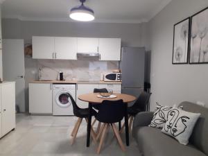a kitchen with a table and chairs in a room at Cruz Del MAR in Chipiona