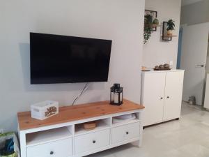 a flat screen tv on a white entertainment center at Cruz Del MAR in Chipiona