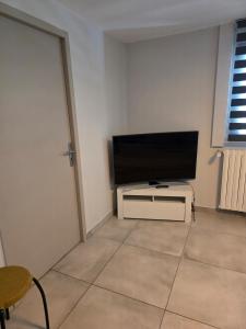 a living room with a flat screen tv on a wall at Studio in a townhouse in Annecy