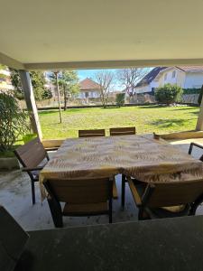 a table and chairs on a patio with a view of a yard at Studio in a townhouse in Annecy
