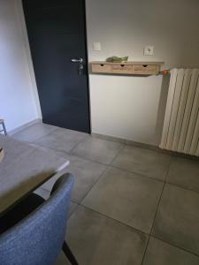 a room with a door and a table and chairs at Studio in a townhouse in Annecy +5 photos