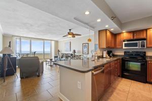 a kitchen with a counter top and a living room at Perdido Sun 1010 in Perdido Key