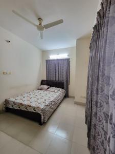 a bedroom with a bed and a window with curtains at Budget Double Bed Single Room by Dhaka Airport Terminal 3 in Dhaka