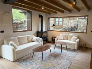 a living room with two couches and a wood stove at La era de Somaniezo in Luriezo +21 photos