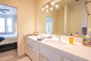 a bathroom with a sink and a large mirror at Charm on Chestnut in Paso Robles +24 photos