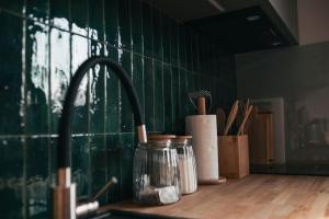 a kitchen counter with a sink and a counter top with a sink at Domki Czarny Bocian in Białogóra +55 photos