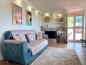 a living room with a couch and a fireplace at Villa Artemis in Graniti