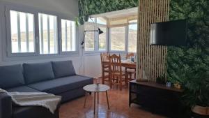 a living room with a couch and a table at Villa Vargas Paraiso in Carrizal