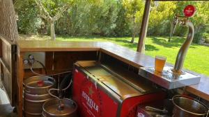 a grill in the back of a truck with a drink at Casa Rural La Casona de Oreja in Aranjuez