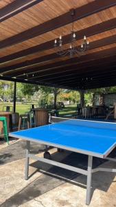 a blue ping pong table sitting under a pavilion at Casa Rural La Casona de Oreja in Aranjuez
