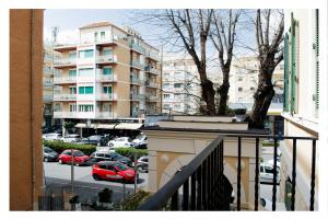 a balcony with a view of a parking lot with cars at Ostia Holiday La Marina in Lido di Ostia