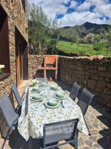 a table with plates on it on a patio at La era de Somaniezo in Luriezo